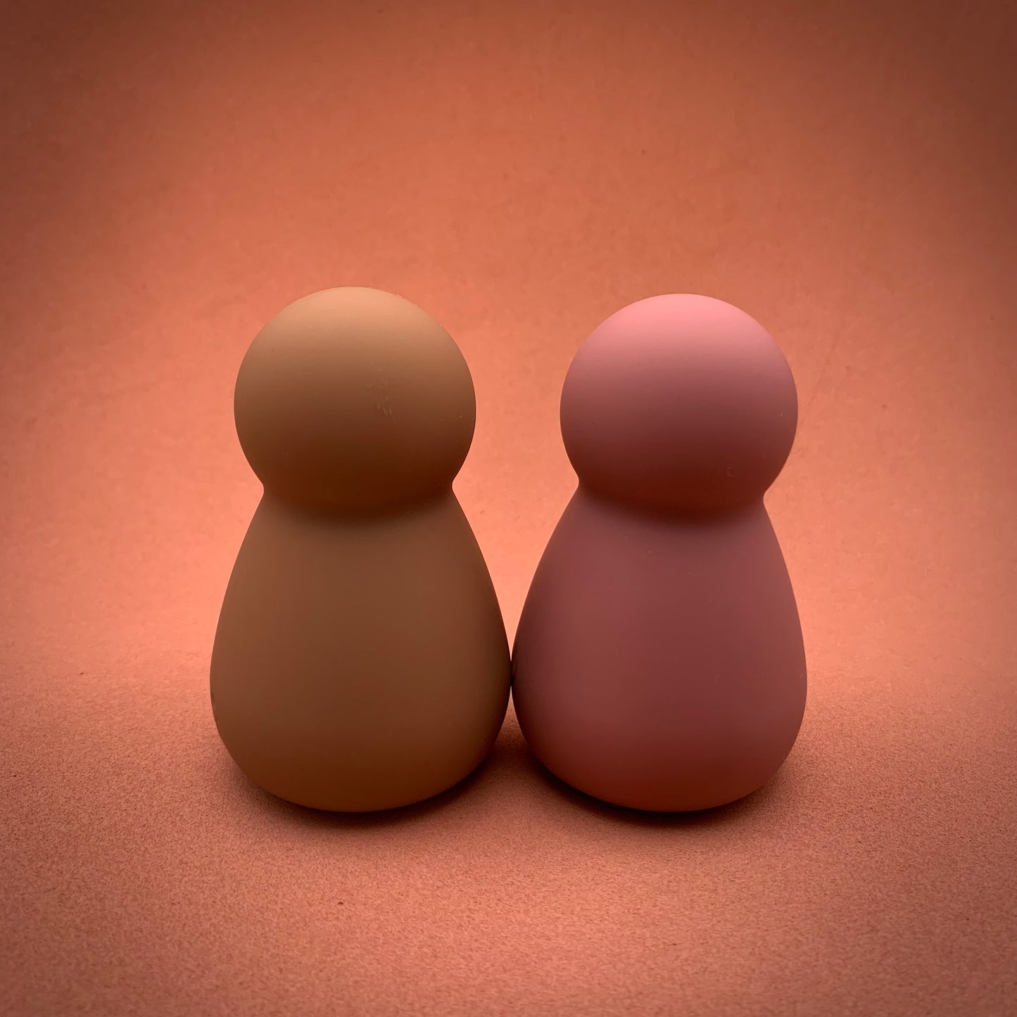 2 mushroom shaped mini clitoral vibrator in rose pink and light brown standing side by side