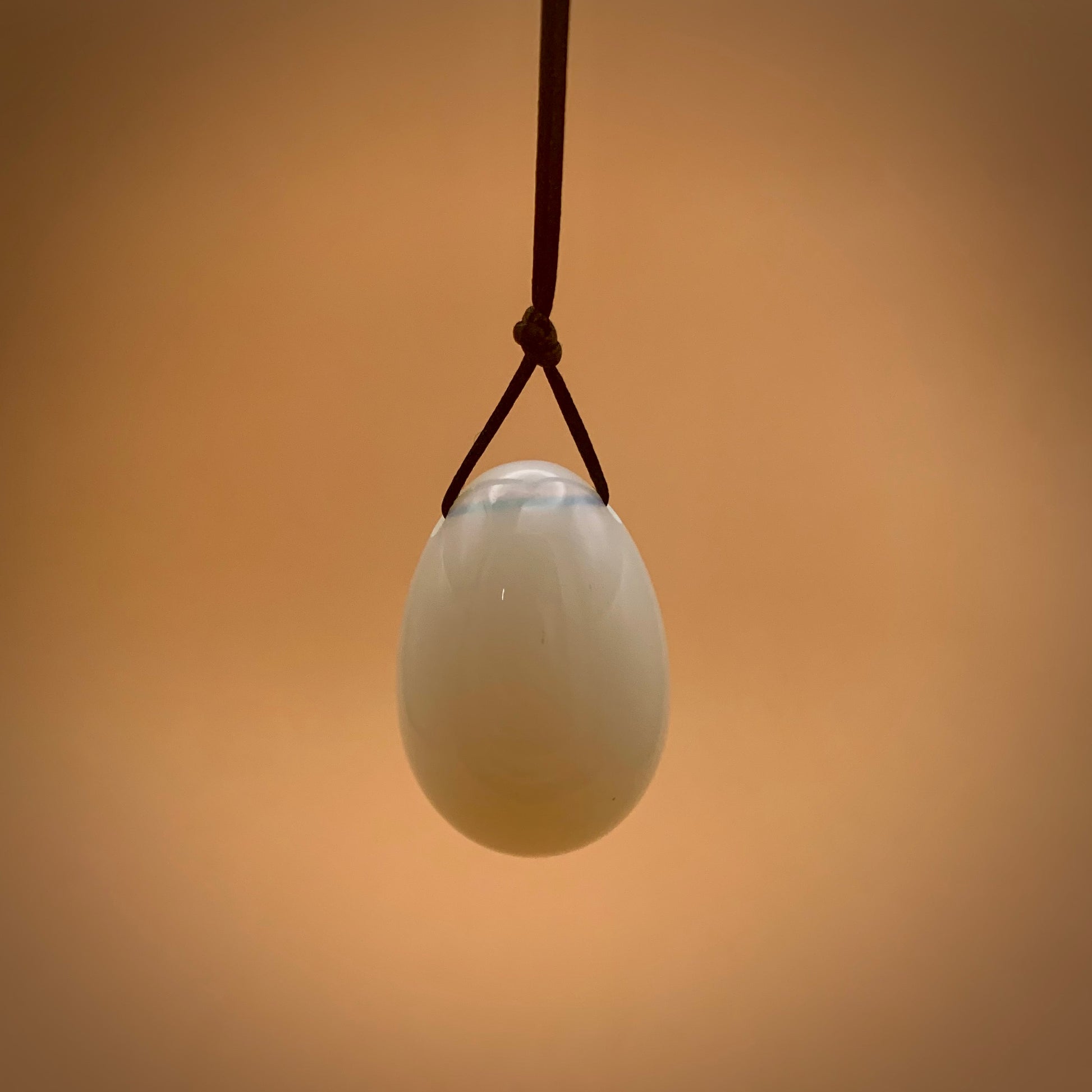 White Opal mineral Kegel egg on a satin string