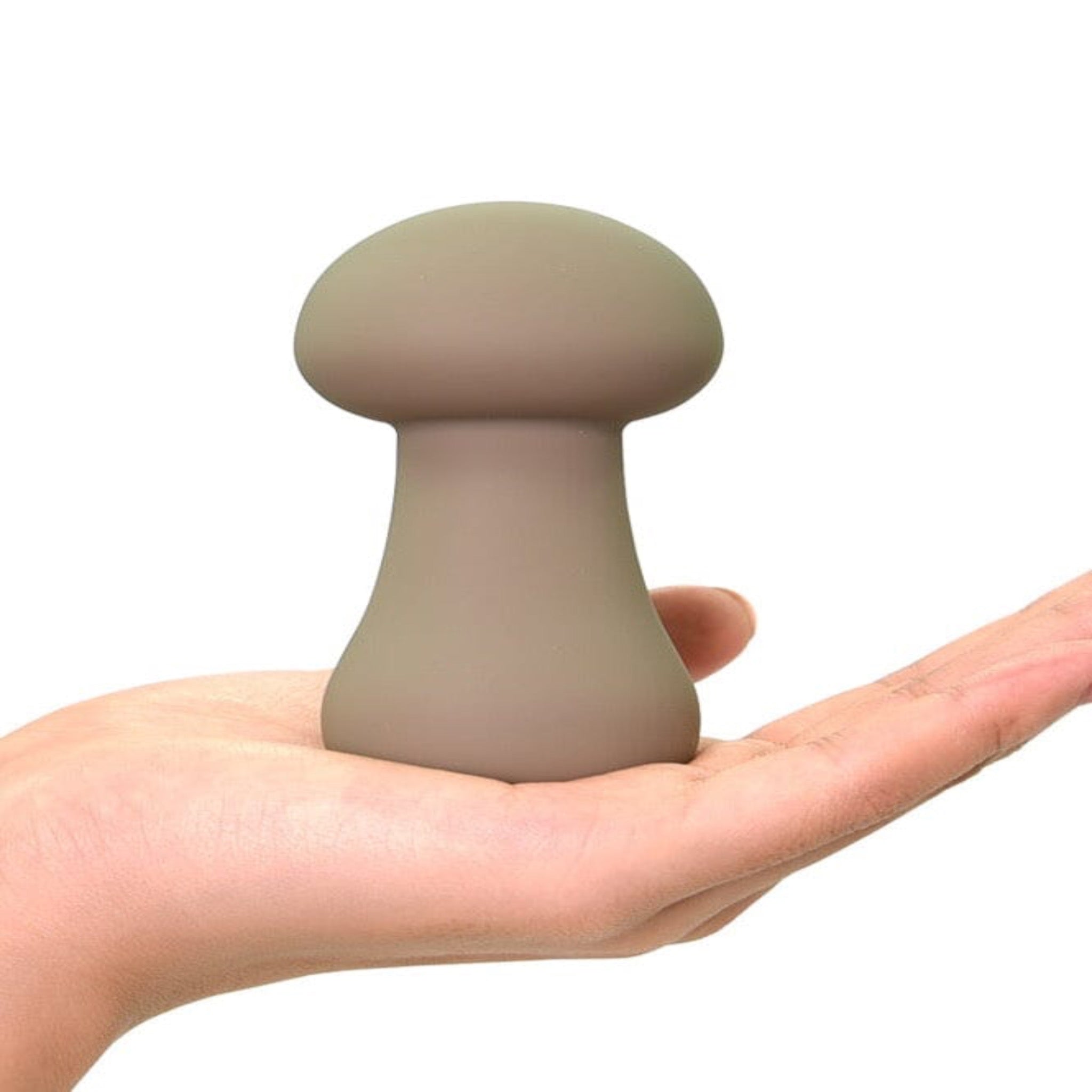 mushroom shaped clitoral vibrator in the palm of a hand